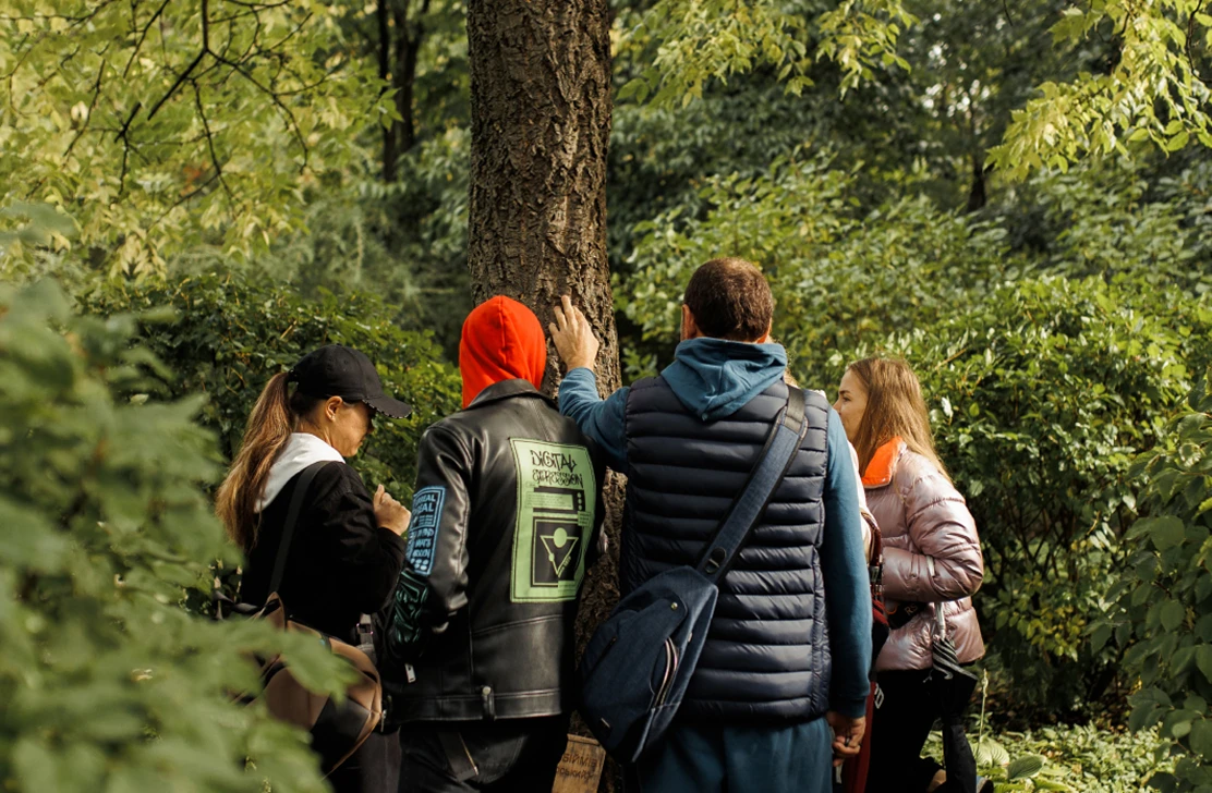Volunteers looking at a tree in a park during a community project