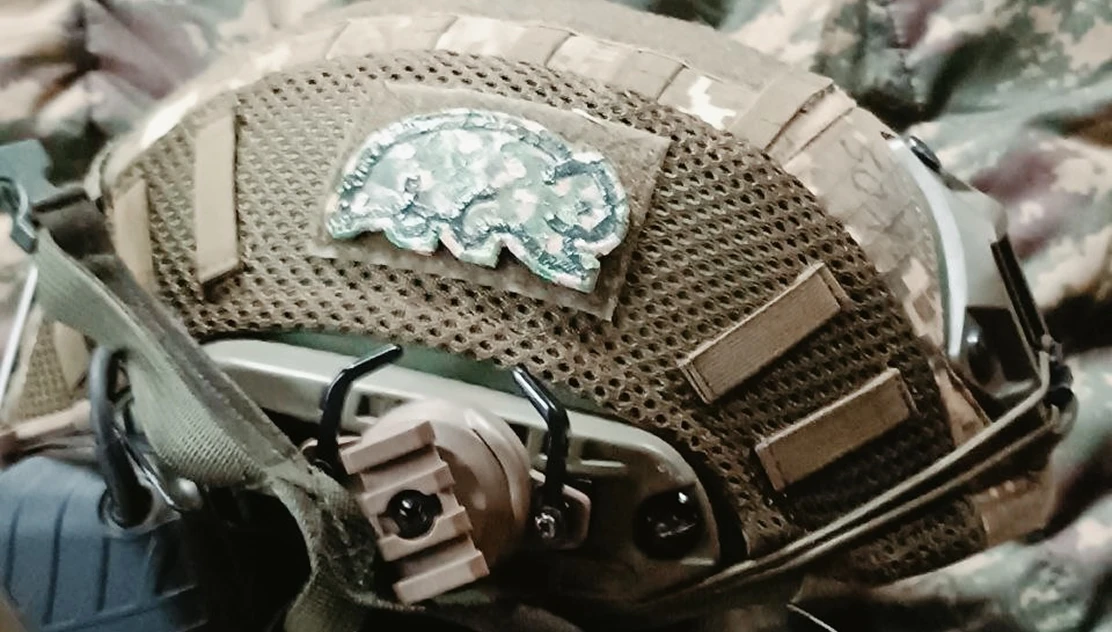 Military helmet with a Go Wombat patch